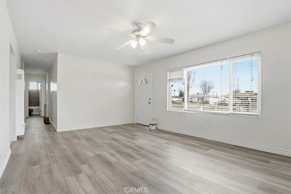 a view of an empty room with wooden floor