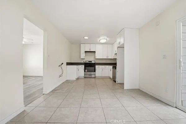 a view of an empty room with floor to ceiling window and wooden floor
