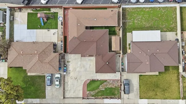 an aerial view of residential houses with outdoor space and a lake view