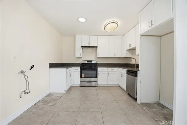 a kitchen with a stove a sink and a refrigerator