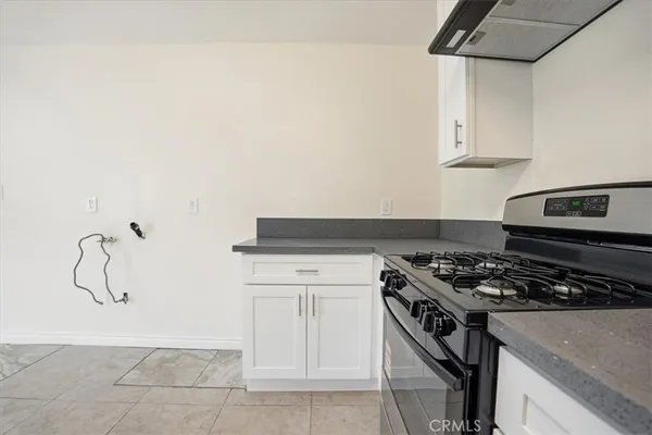 a kitchen with granite countertop a stove and a sink