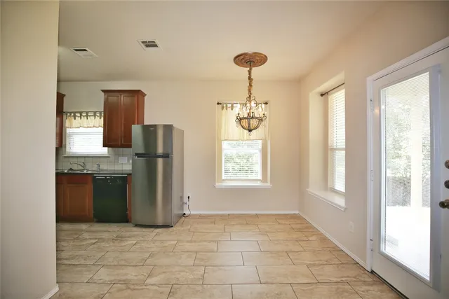 a view of a kitchen with a sink refrigerator and window