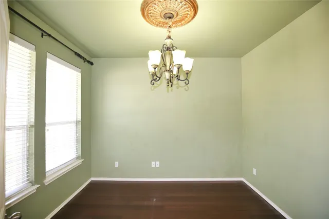 a room with wooden floor and window