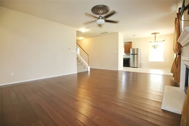 a view of a room with wooden floor