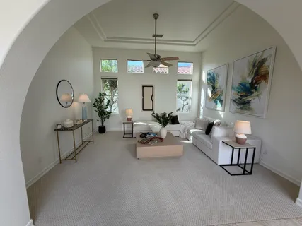 a living room with furniture and a chandelier