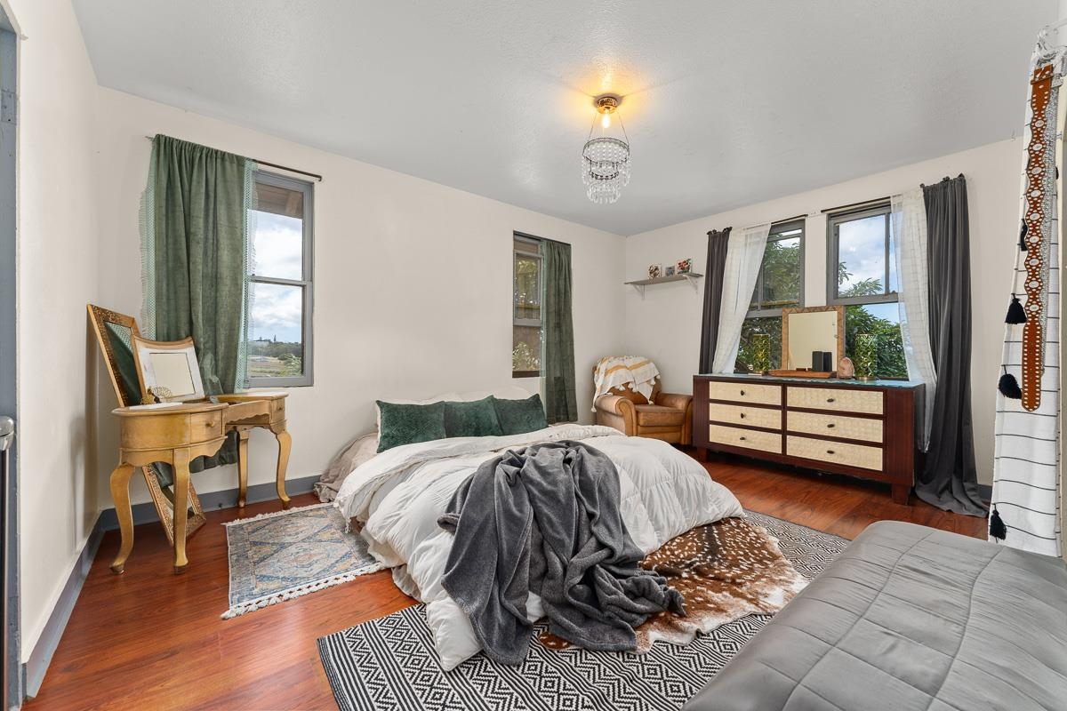 2970 Kailiili Road, Unit 1B Haiku, HI 96708 - Photo 17 of 47 a bedroom with a bed a mirror and a window