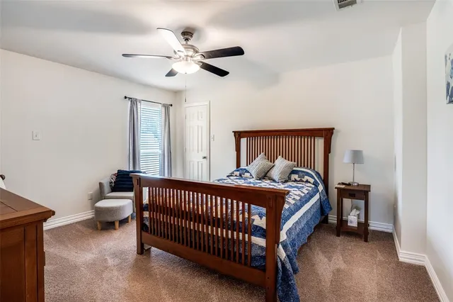 a bed sitting in a bedroom next to a window