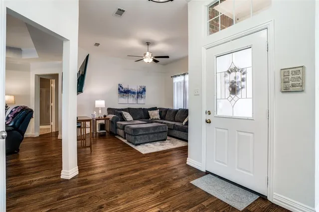 a living room with furniture and wooden floor