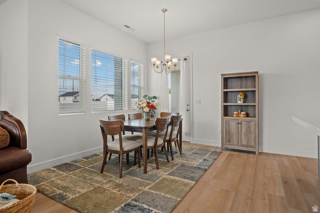 531 North Legend Way West, Unit D Mapleton, UT 84664 - Photo 9 of 42 Dining room with light wood-style flooring and hanging lights