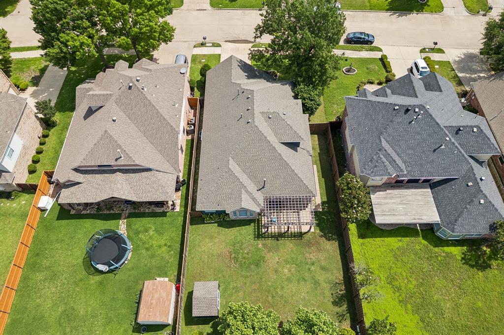 9217 Inverness Drive Rowlett, TX 75089 - Photo 31 of 40 Large Backyard Layout — The aerial view highlights the private backyard, pergola-covered patio, storage shed, and open lawn space ready for outdoor enjoyment.