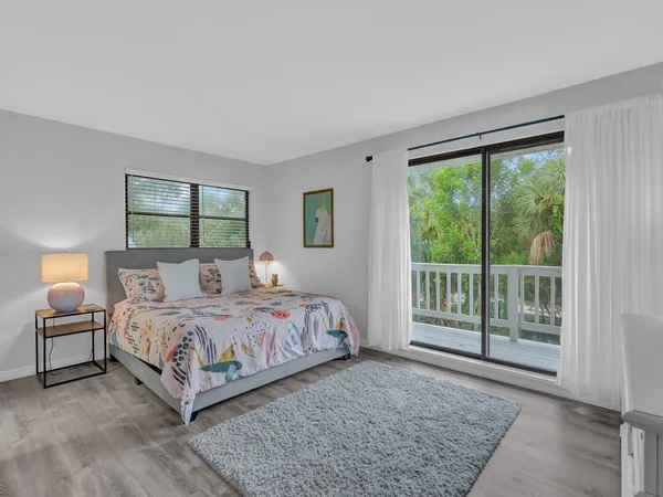 a bedroom with a large bed and a large window