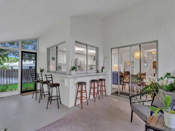 a dining hall with couches a coffee table and chairs