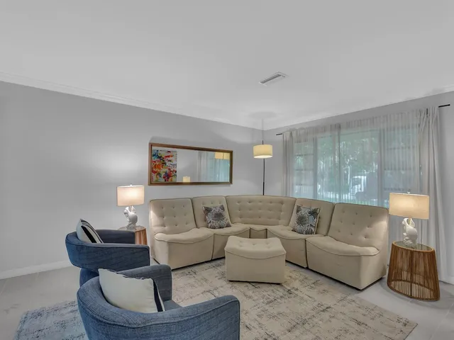 a living room with furniture and a painting