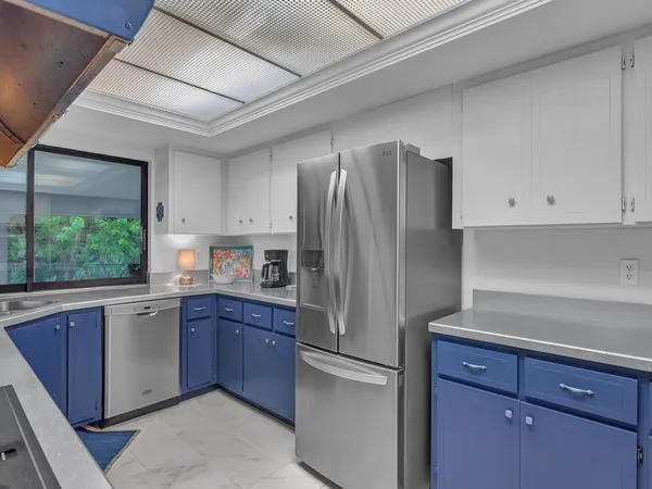 a kitchen with stainless steel appliances granite countertop a refrigerator sink and cabinets