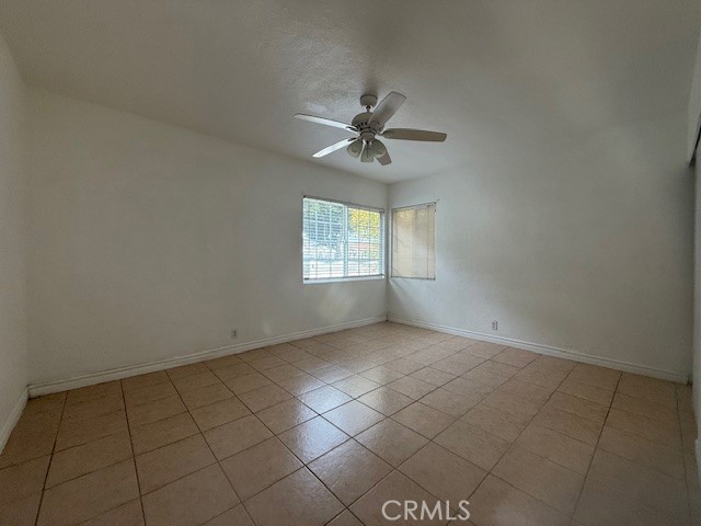 14810 South Cookacre Avenue Compton, CA 90221 - Photo 11 of 13 an empty room with windows and fan