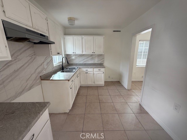 14810 South Cookacre Avenue Compton, CA 90221 - Photo 5 of 13 a kitchen with a sink a stove and cabinets