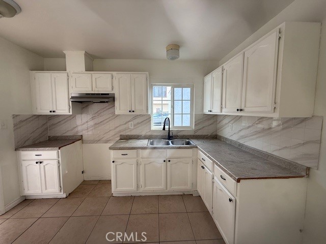 14810 South Cookacre Avenue Compton, CA 90221 - Photo 6 of 13 a kitchen with granite countertop white cabinets white stainless steel appliances with a sink and dishwasher
