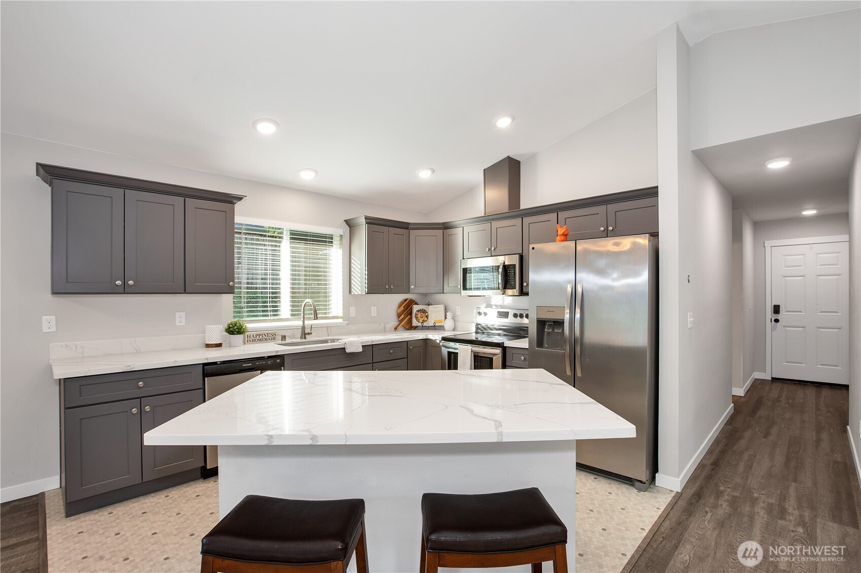 17643 Loop Lane Southeast Yelm, WA 98597 - Photo 14 of 34 a kitchen with stainless steel appliances a sink a stove a refrigerator with cabinets and wooden floor