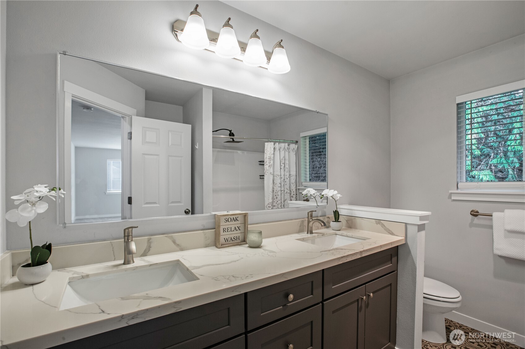 17643 Loop Lane Southeast Yelm, WA 98597 - Photo 23 of 34 a bathroom with a granite countertop sink a toilet and a mirror