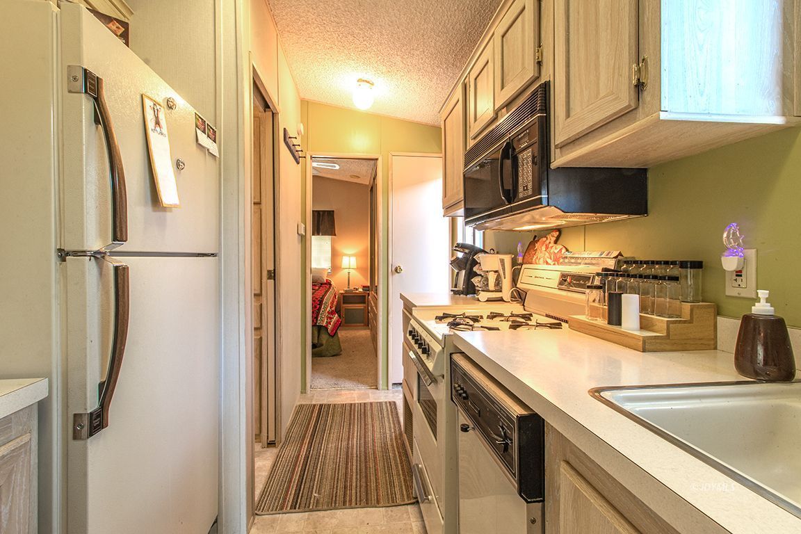 21 Pine Cove Road Idyllwild, CA 92549 - Photo 14 of 22 a kitchen with stainless steel appliances granite countertop a refrigerator a stove and a sink