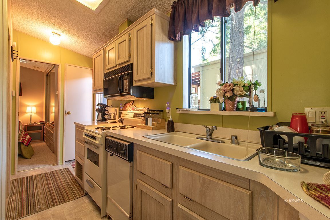 21 Pine Cove Road Idyllwild, CA 92549 - Photo 15 of 22 a kitchen with a sink stove and cabinets