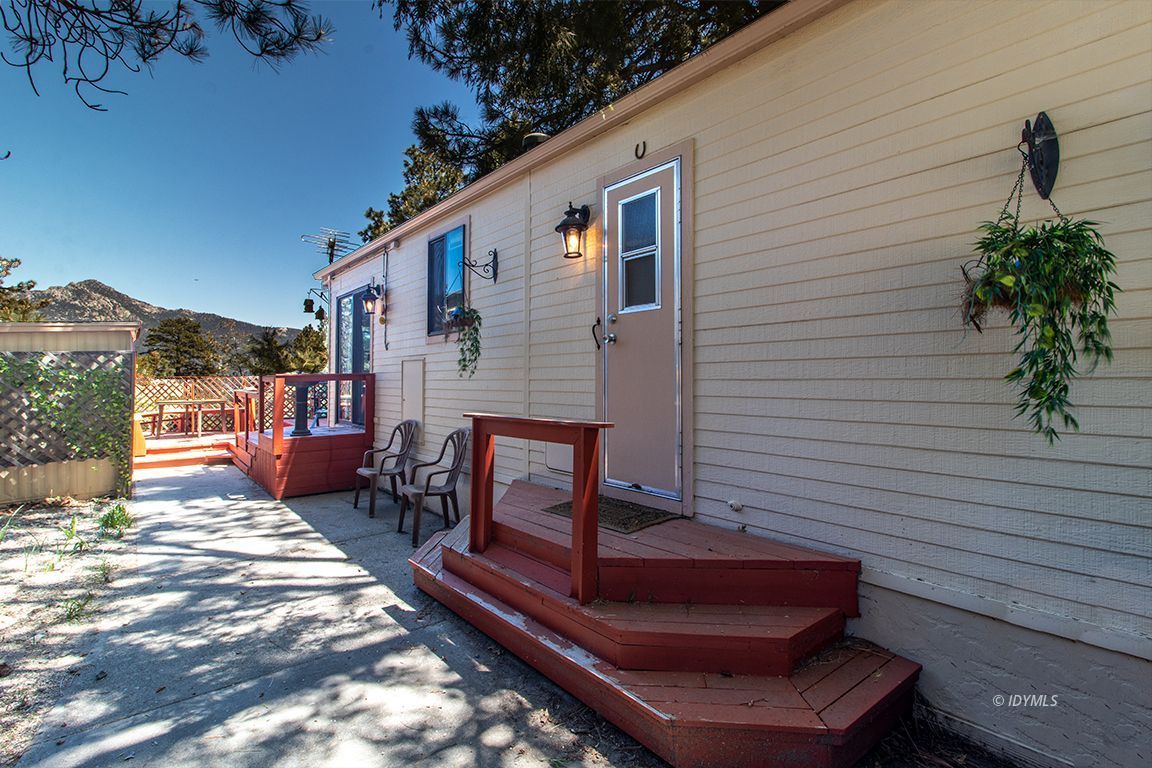 21 Pine Cove Road Idyllwild, CA 92549 - Photo 4 of 22 a bench is sitting in front of a house