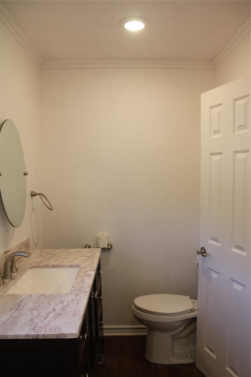101 North 2 Nd Mullin, TX 76864 - Photo 11 of 34 a bathroom with a granite countertop sink and a toilet