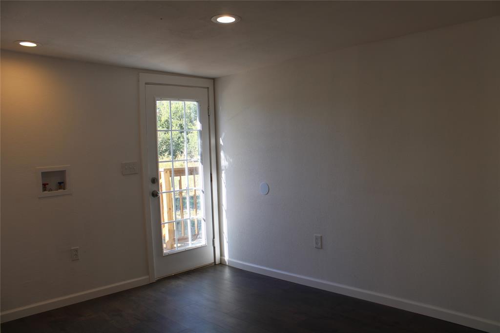 101 North 2 Nd Mullin, TX 76864 - Photo 16 of 34 a view of an empty room with wooden floor and a window