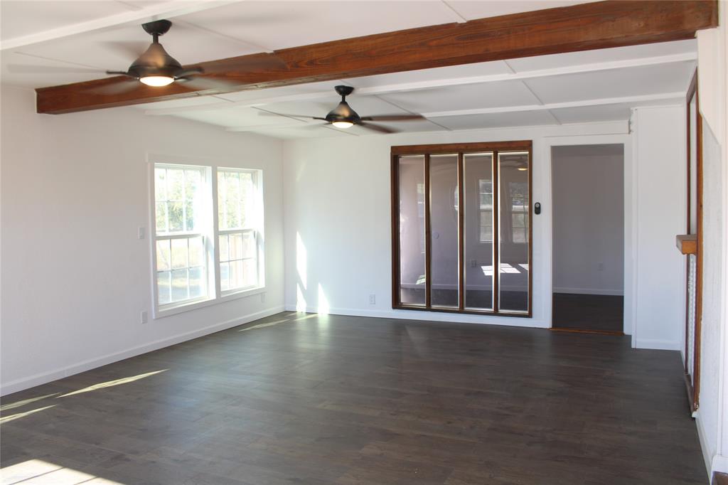 101 North 2 Nd Mullin, TX 76864 - Photo 3 of 34 a view of an empty room with wooden floor and a window