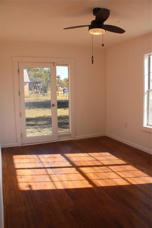101 North 2 Nd Mullin, TX 76864 - Photo 6 of 34 a view of empty room with wooden floor and fan
