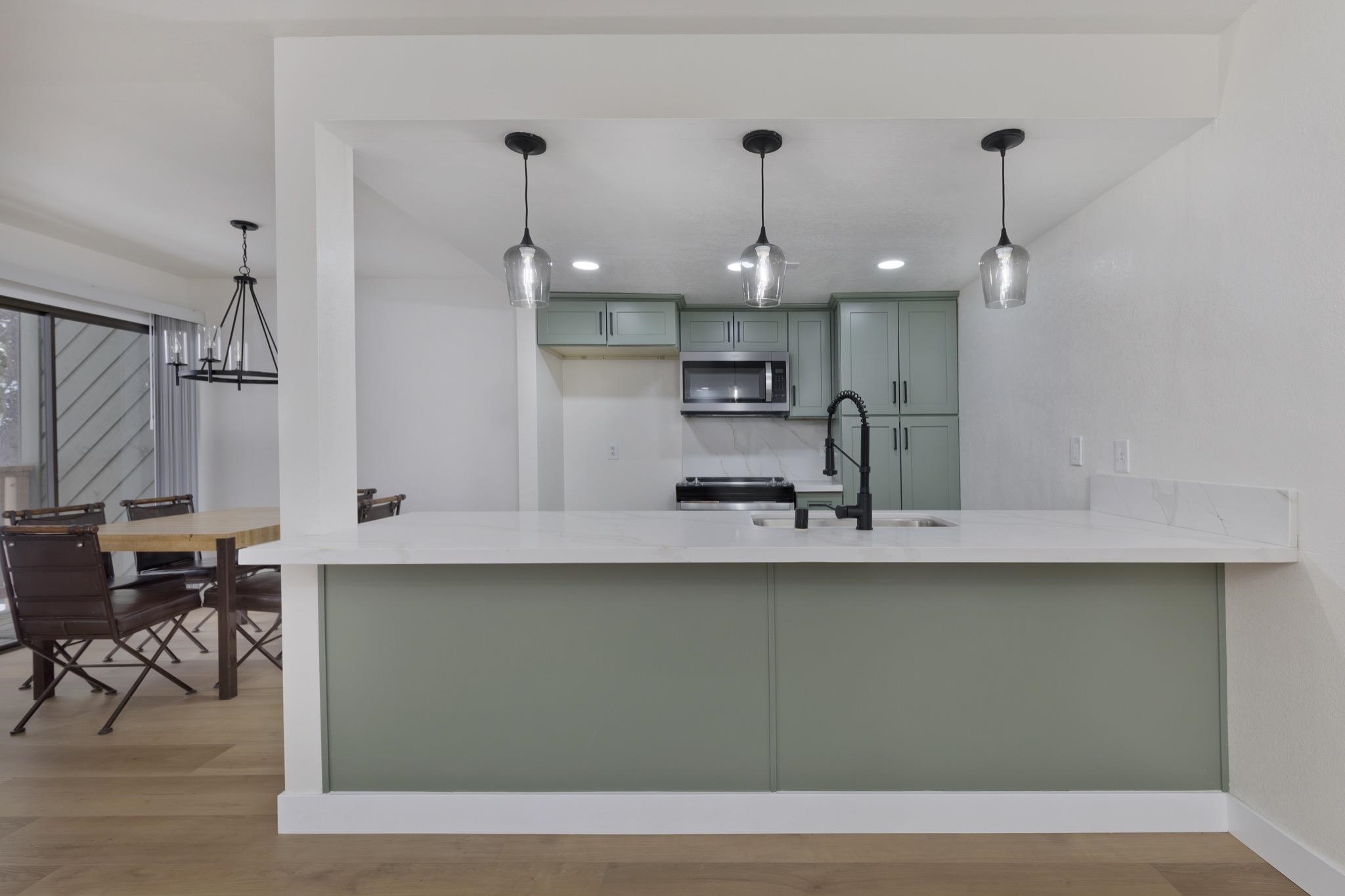 152 Viewpoint Road, Unit 105 Mammoth Lakes, CA 93546 - Photo 1 of 29 a kitchen with kitchen island sink stove and cabinets