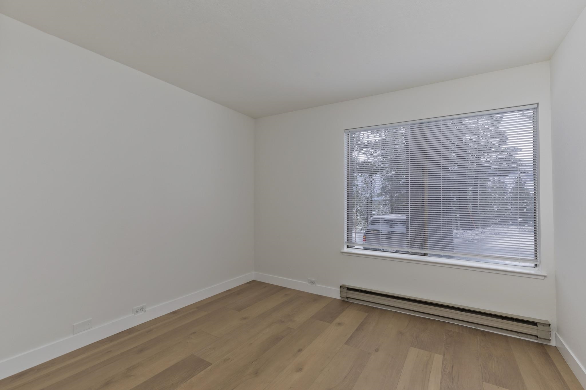 152 Viewpoint Road, Unit 105 Mammoth Lakes, CA 93546 - Photo 18 of 29 a view of an empty room with wooden floor and a window