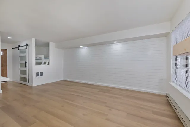 a view of a dining room with a table and chairs