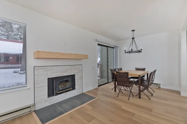 a view of a dining room with a table and chairs