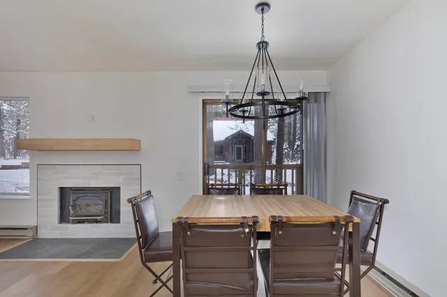 a view of a kitchen with furniture and wooden floor