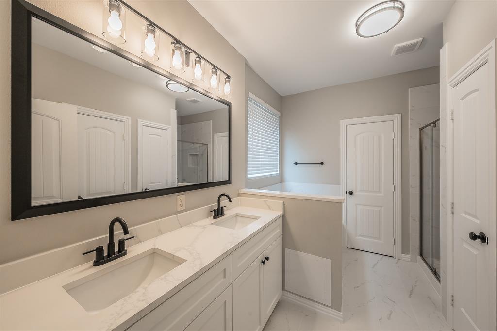 412 Hideaway Road McKinney, TX 75072 - Photo 20 of 40 a bathroom with a sink and a mirror