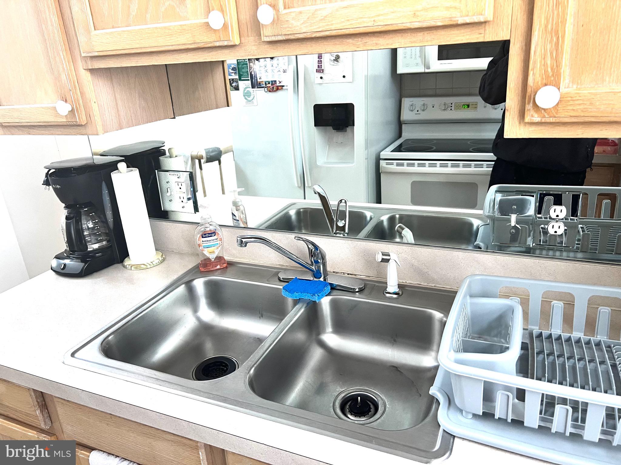 37 Hunters Point Millsboro, DE 19966 - Photo 8 of 38 a kitchen counter with kitchen island a sink and white cabinets