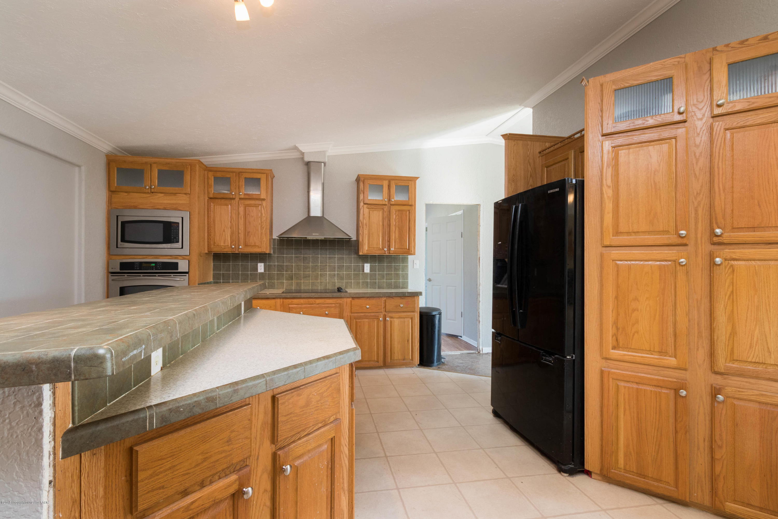 5015 Arden Road Amarillo, TX 79110 - Photo 14 of 38 a kitchen with a refrigerator and a sink