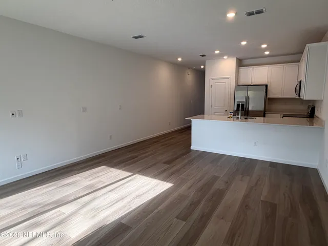 a view of kitchen with cabinets and wooden floor