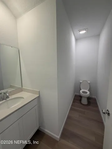 a bathroom with a sink toilet and a mirror