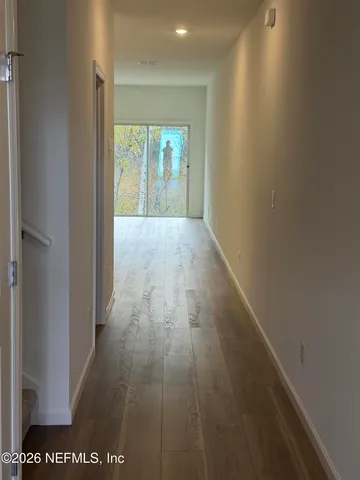 a view of hallway with wooden floor