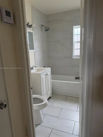 a bathroom with a bathtub a toilet and a shower
