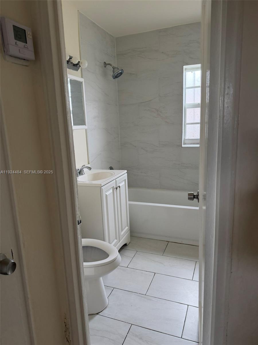 791 East 21st Street Hialeah, FL 33013 - Photo 16 of 19 a bathroom with a bathtub a toilet and a shower