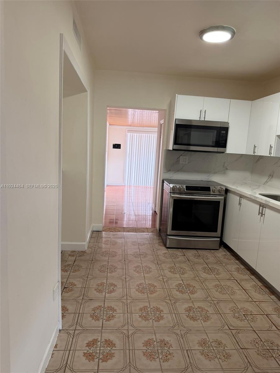 791 East 21st Street Hialeah, FL 33013 - Photo 2 of 19 a view of a kitchen with microwave and cabinets