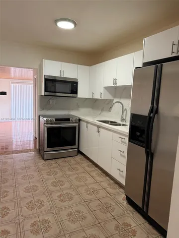 a kitchen with a sink stove and refrigerator