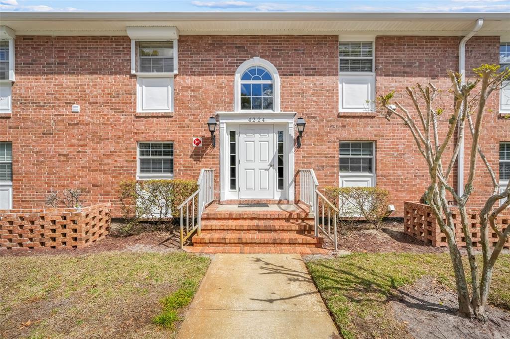 4224 Lake Underhill Road, Unit 8B8 Orlando, FL 32803 - Photo 1 of 47 a front view of a house with a yard