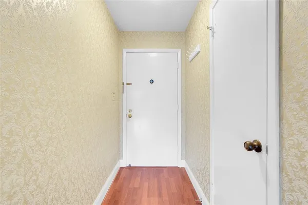 a view of a room with wooden floor