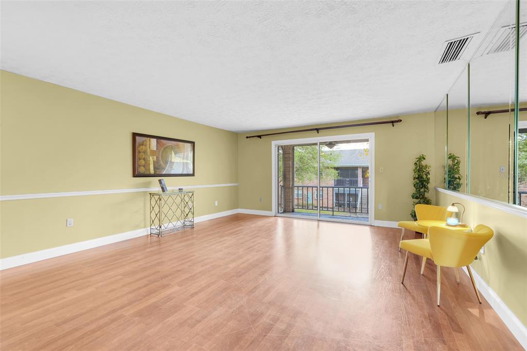 4224 Lake Underhill Road, Unit 8B8 Orlando, FL 32803 - Photo 14 of 47 a view of a livingroom with furniture window and wooden floor