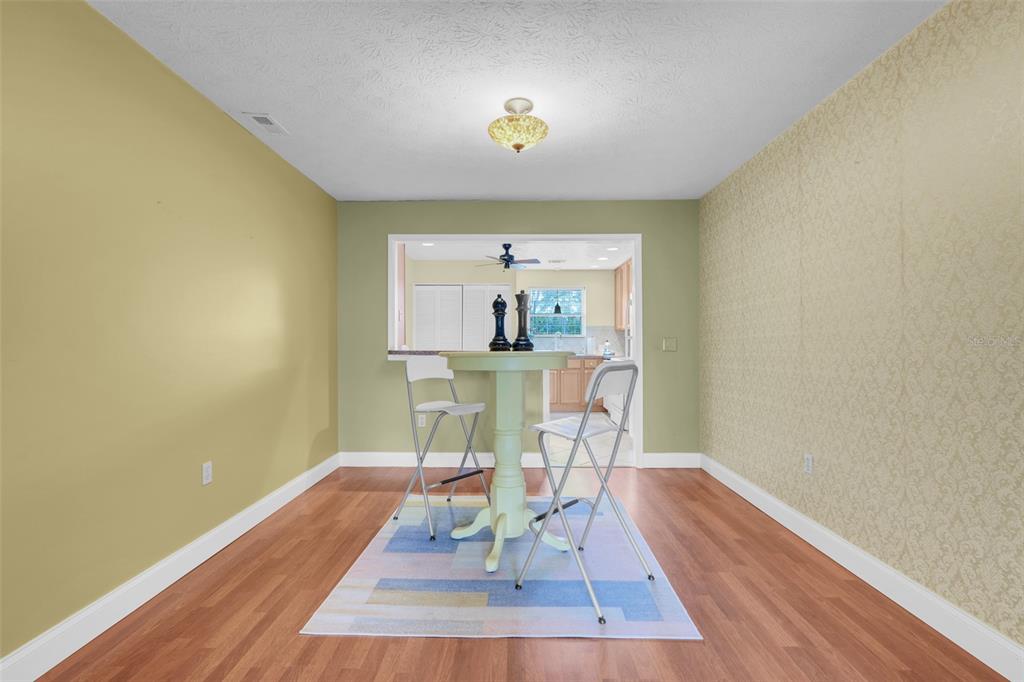 4224 Lake Underhill Road, Unit 8B8 Orlando, FL 32803 - Photo 15 of 47 a view of a dining room with furniture and wooden floor
