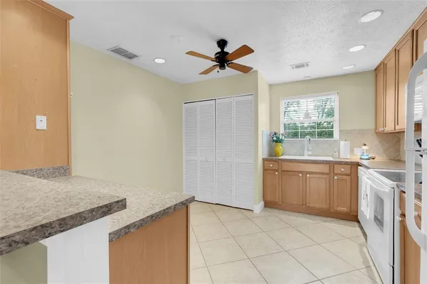 a kitchen with a sink cabinets and window